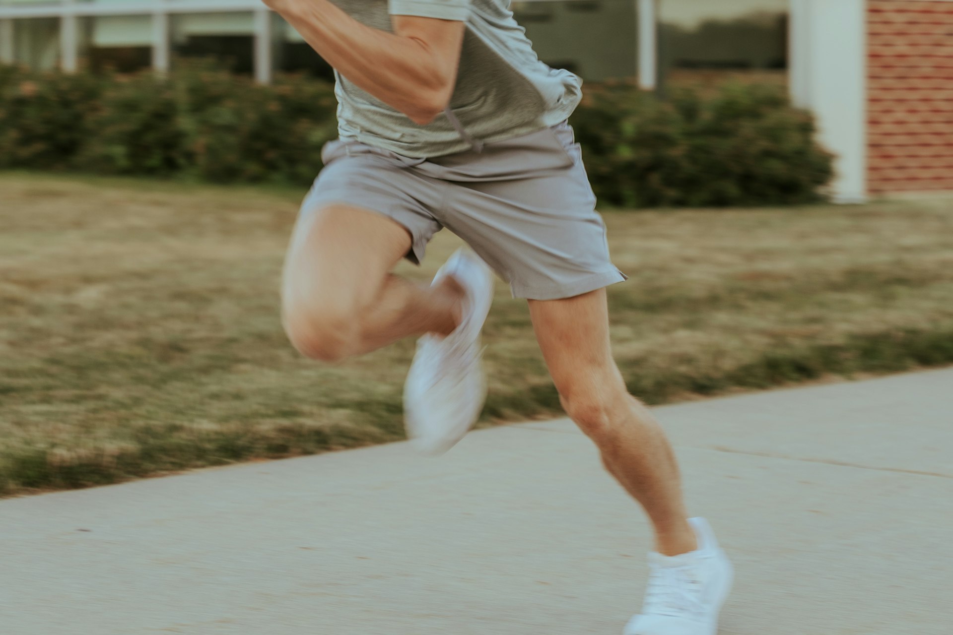 a man in grey shirt and shorts playing a game of tennis